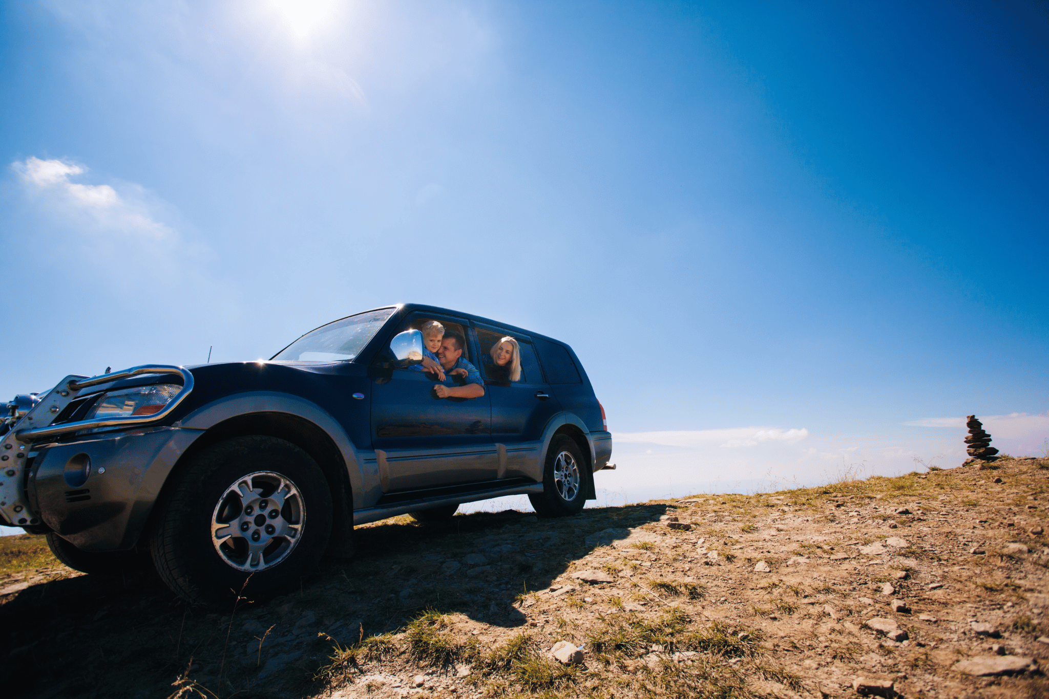 Family enjoying their SUV on an adventure overlooking scenic views