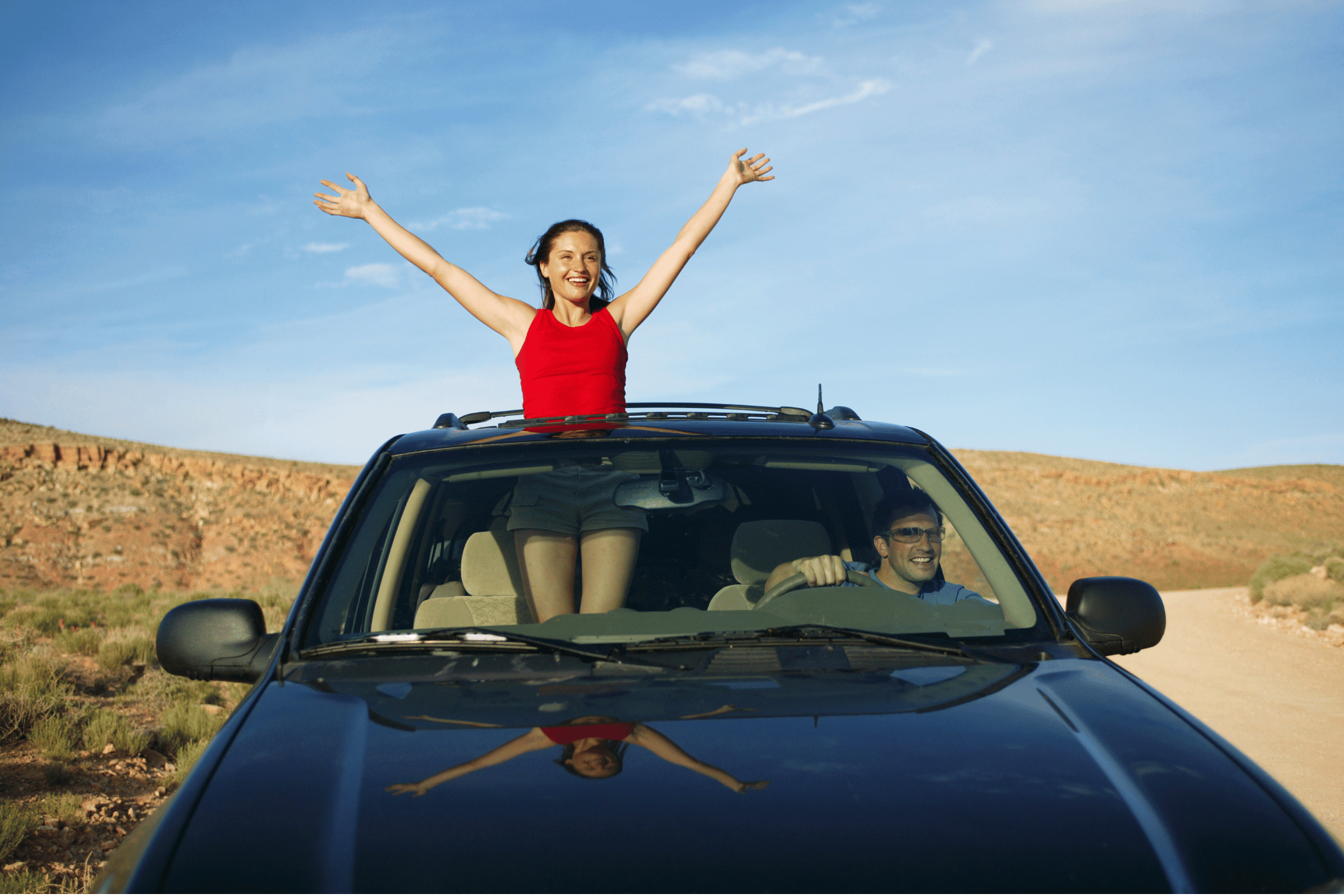 Happy couple celebrating in their new SUV