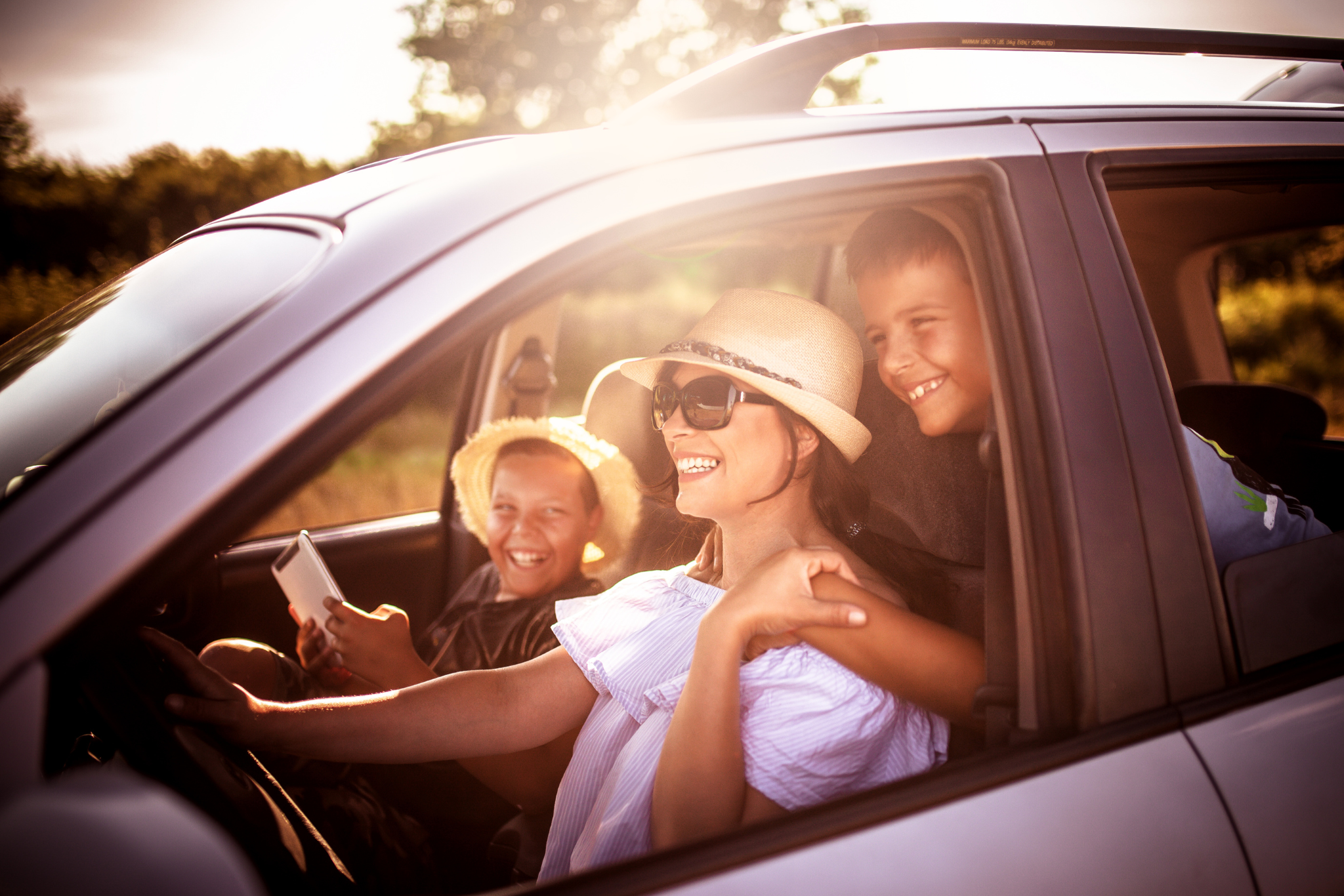 Happy mom with kids enjoying their sedan on the Emerald Coast