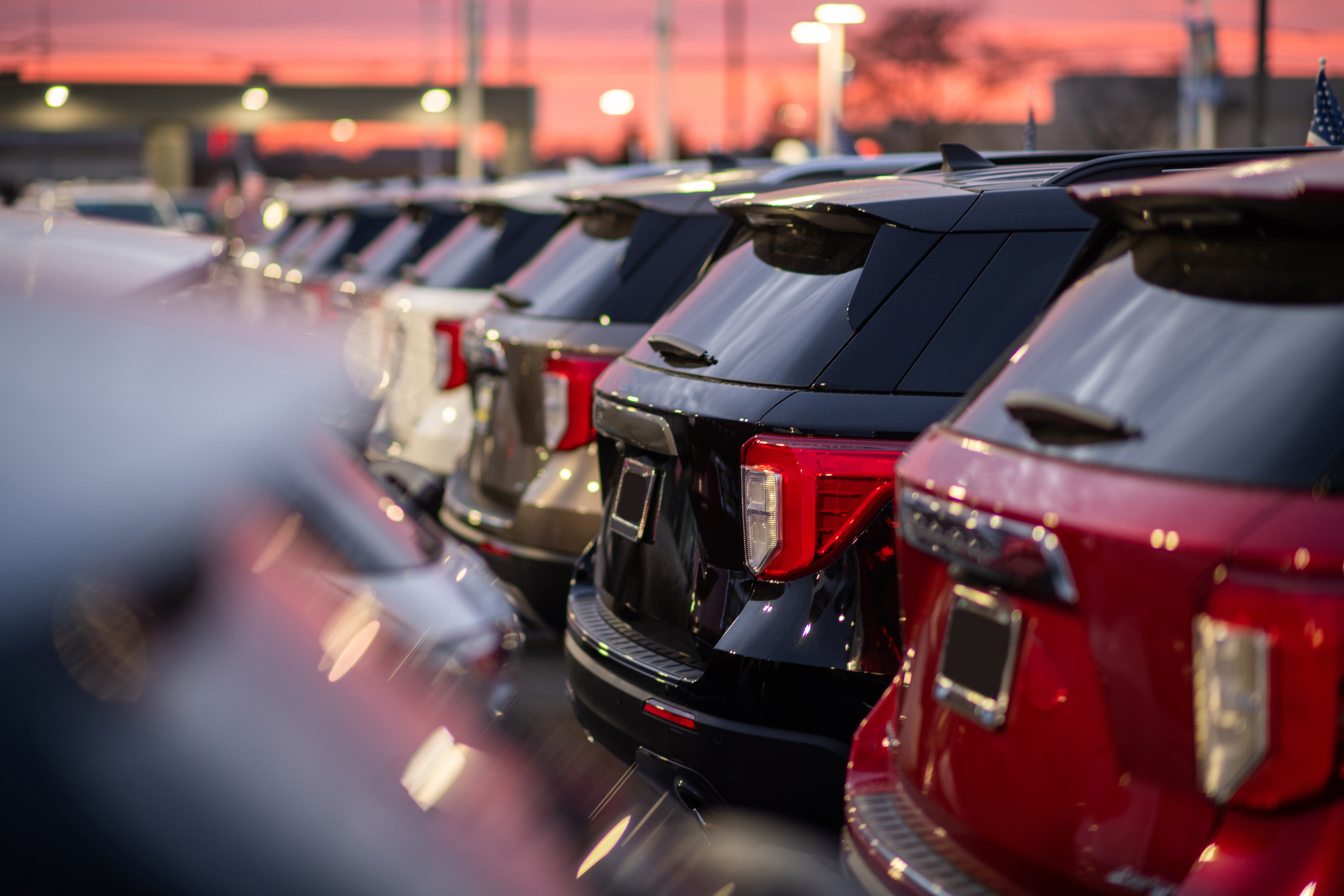 Row of quality used SUVs available for inspection at a dealership
