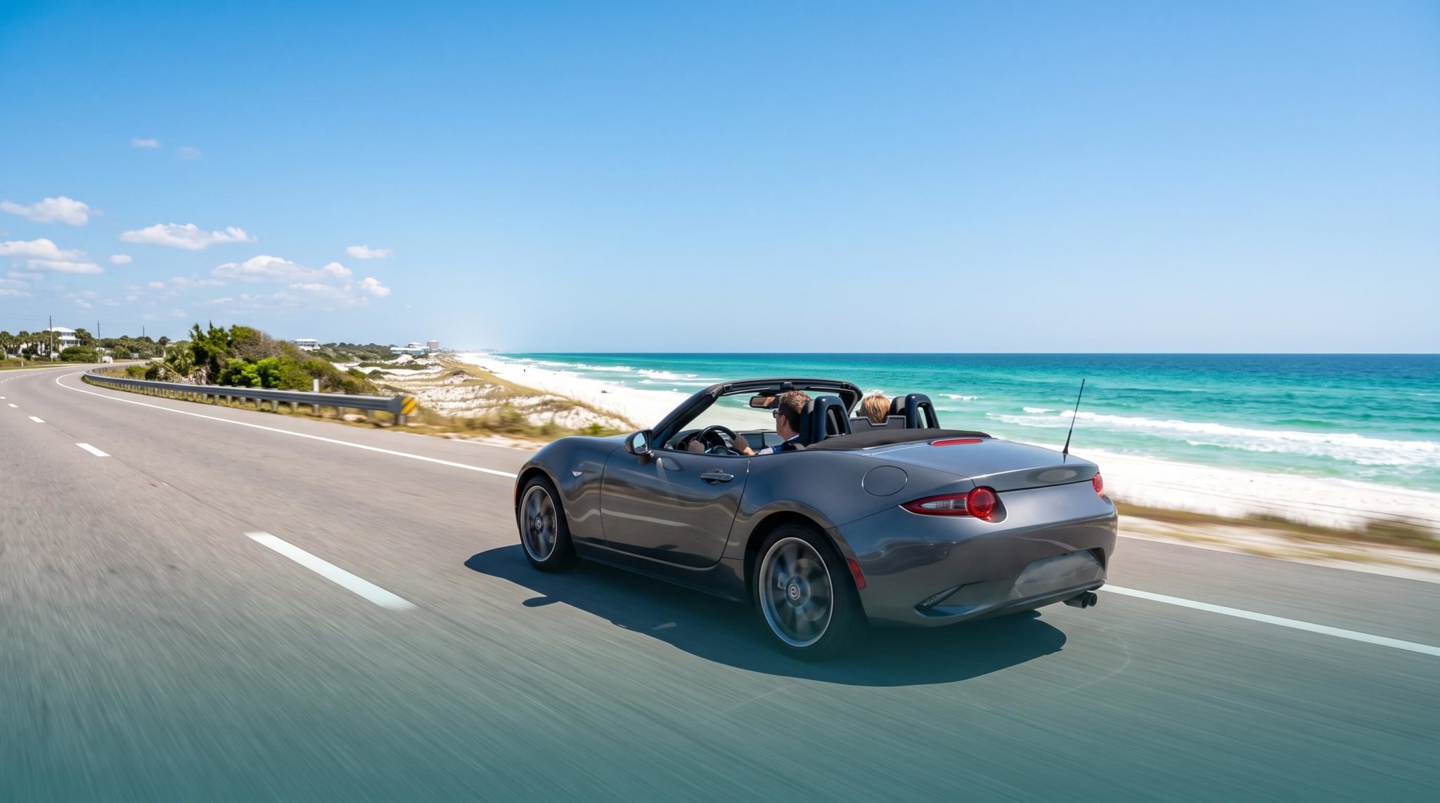 Convertible driving along the Emerald Coast in Florida with the top down